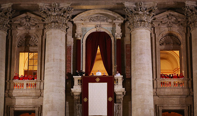 A black and white profile shot of Pope Francis from the shoulders up. 