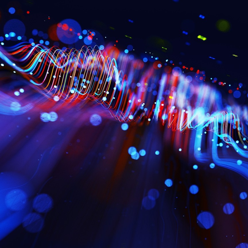 Digital generated image of abstract flowing data made out of glowing blue and red splines moving away from camera on black background.