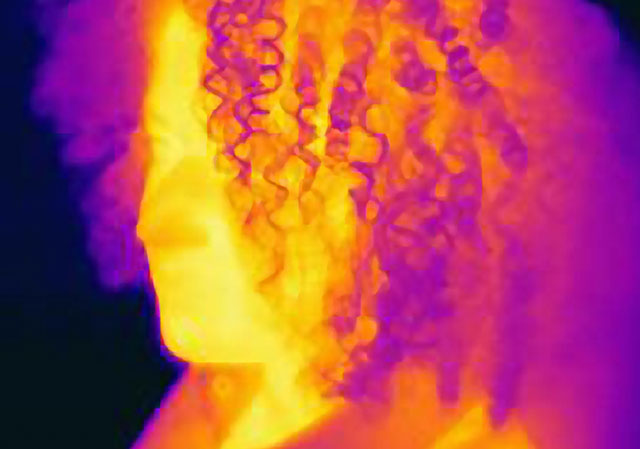 Infrared thermal imaging shows heat distribution across a woman's face.