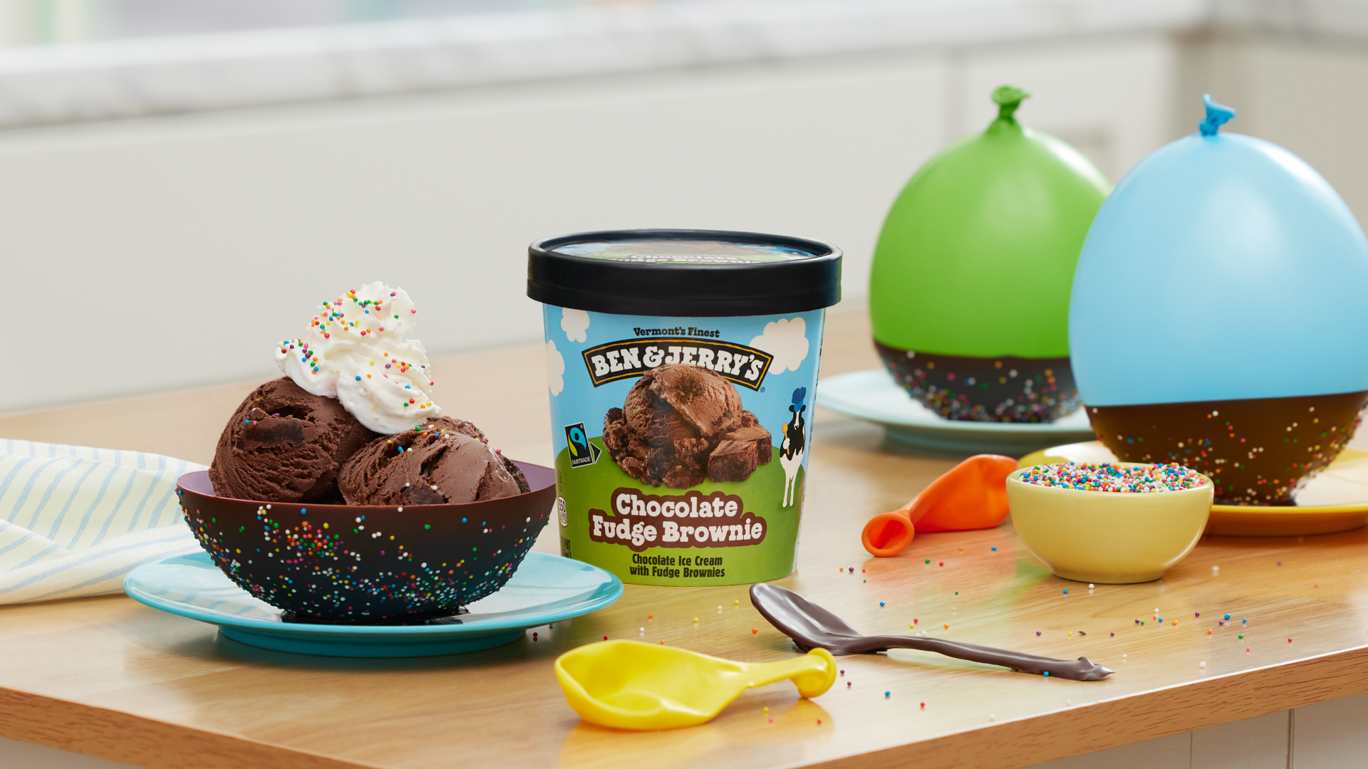 Chocolate sundae in an edible chocolate bowl. Pint of Ben & Jerry's Chocolate Fudge Brownie ice cream nearby.