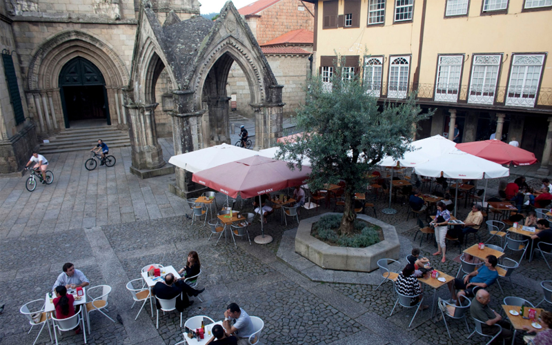 Locals and visitors hang out in Largo da Oliveira, the heart of old town Guimarães.