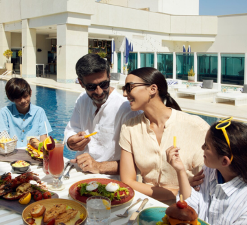 Family eating by the pool