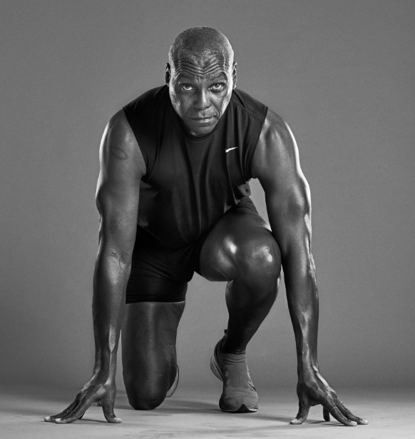 A black-and-white photograph of Carl Lewis