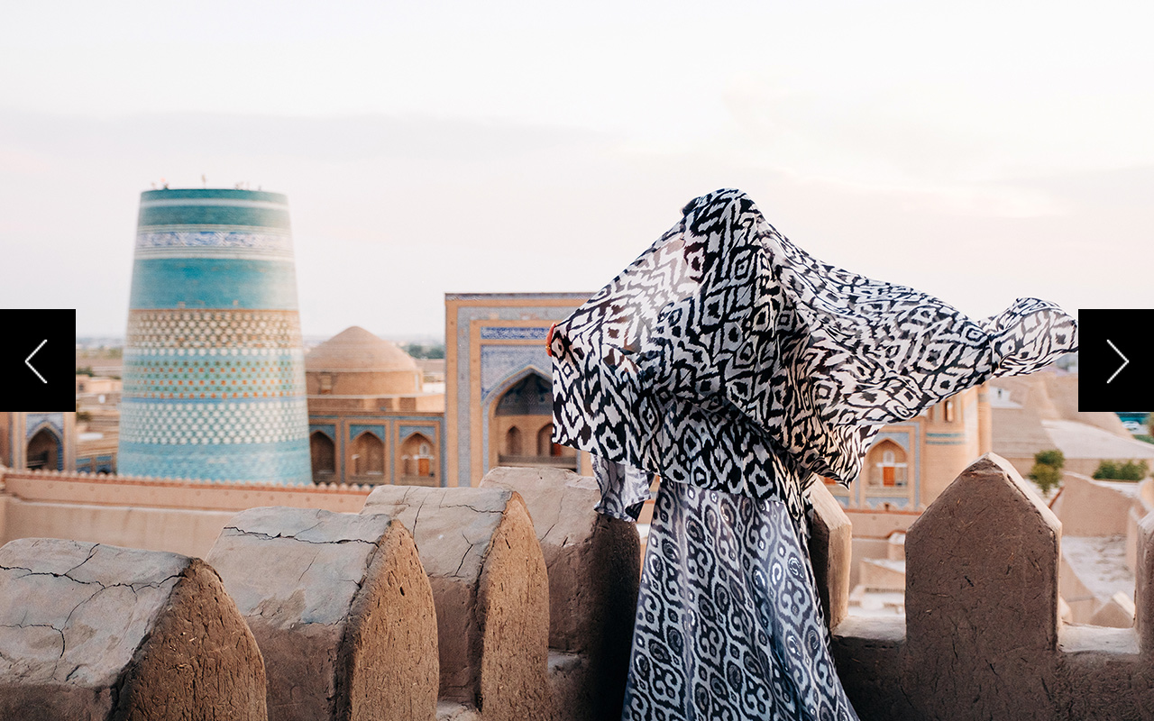 A woman looks out over the skyline of Khiva